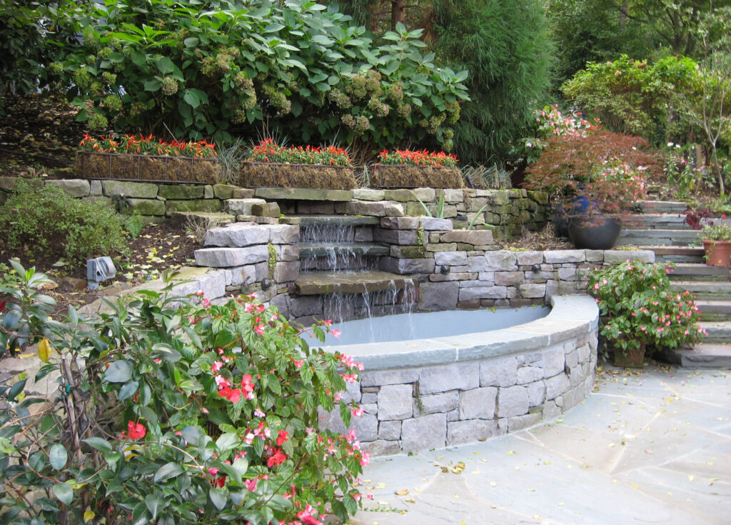 Stone fountain with surrounding gardens